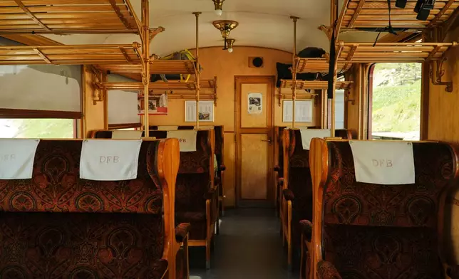 Interior view of a historic passenger carriage in service on the Furka railway during a stop at the Furka station near Realp, Switzerland, Friday, June 26, 2026. (AP Photo/Niccolo Lupone)