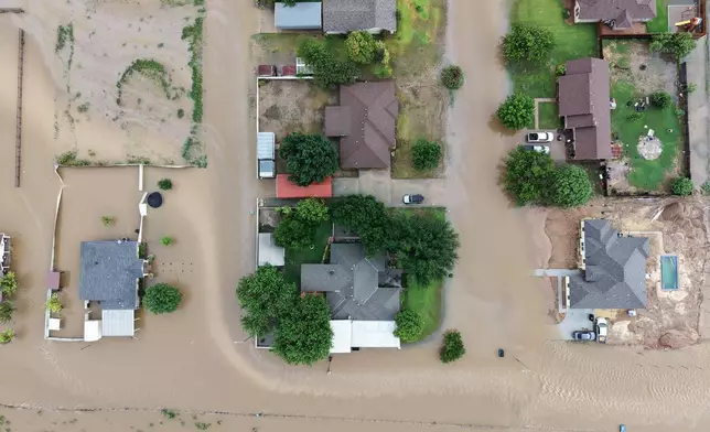 An aerial views shows flooding on Friday, July 17, 2026, in Ozona, Texas. (AP Photo/Gerald Herbert)