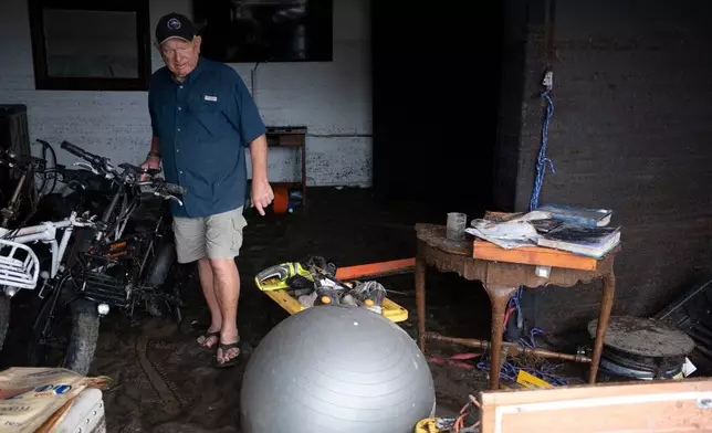 Bob Bettes assesses damage to his belongings after flooding reached the Buckhorn Lake Resort RV Park along West Goat Creek near the Guadalupe River on Friday, July 17, 2026, in Kerrville, Texas. (AP Photo/Joel Angel Juarez)
