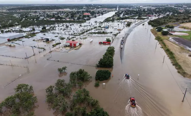 An aerial views shows flooding on Friday, July 17, 2026, in Ozona, Texas. (AP Photo/Gerald Herbert)