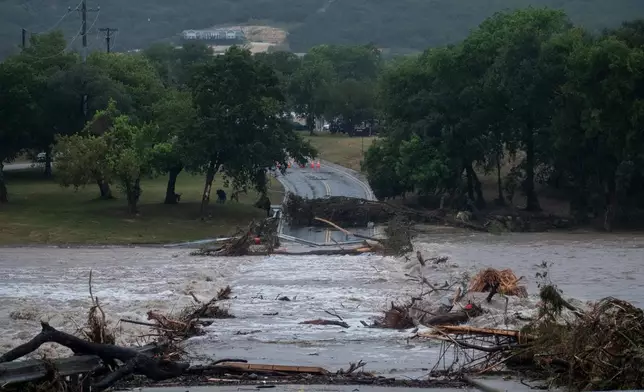 Flooding blocks off G Street along the Guadalupe River on Thursday, July 16, 2026, in Kerrville, Texas. (AP Photo/Joel Angel Juarez)