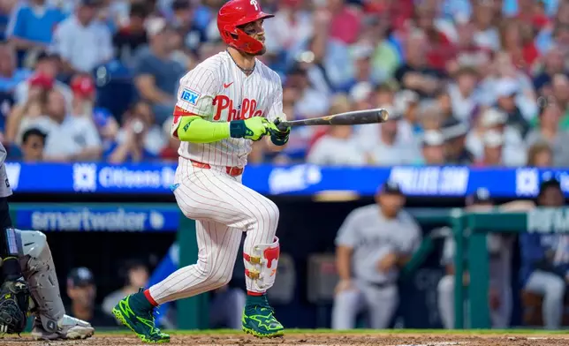 Philadelphia Phillies' Bryce Harper doubles during the third inning of a baseball game against the New York Yankees, Sunday, July 26, 2026, in Philadelphia. (AP Photo/Chris Szagola)