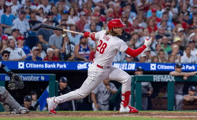 Philadelphia Phillies' Alec Bohm hits a three run double during the third inning of a baseball game against the New York Yankees, Sunday, July 26, 2026, in Philadelphia. (AP Photo/Chris Szagola)