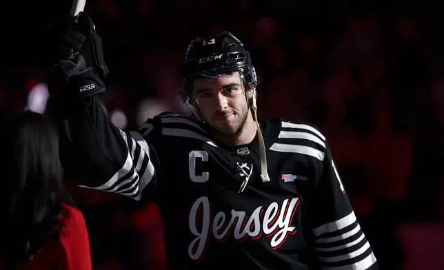 FILE - New Jersey Devils center Nico Hischier gestures after overtime of an NHL hockey game against the Ottawa Senators, April 12, 2026, in Newark, N.J. (AP Photo/Adam Hunger, File)