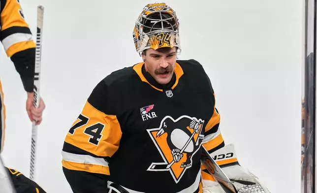 FILE - Pittsburgh Penguins goaltender Stuart Skinner takes a timeout during the first period of an NHL hockey game against the Dallas Stars in Pittsburgh, March 28, 2026. (AP Photo/Gene J. Puskar, File)