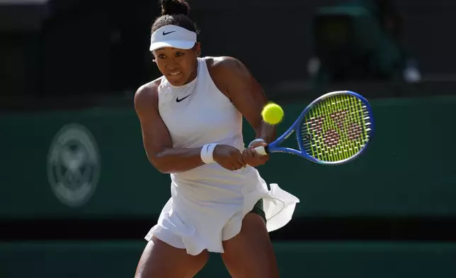 Naomi Osaka of Japan returns the ball to Karolina Muchova of Czech Republic in their quarter-final women's singles match at the Wimbledon Tennis Championships in London, Tuesday, July 7, 2026. (AP Photo/Kin Cheung)