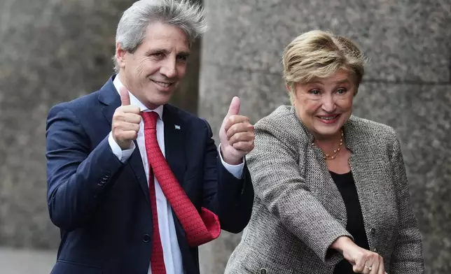 President of the International Monetary Fund Kristalina Georgieva, right, and Argentina Economy Minister Luis Caputo pose for a photo as they arrive at the Economy Ministry for a meeting in Buenos Aires, Argentina, Monday, July 27, 2026. (AP Photo/Gustavo Garello)