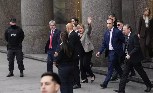 President of the International Monetary Fund Kristalina Georgieva waves as she leaves the Economy Ministry after a meeting with Argentina Economy Minister Luis Caputo, left, in Buenos Aires, Argentina, Monday, July 27, 2026. (AP Photo/Gustavo Garello)