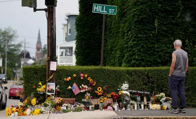 A man pauses to view a makeshift memorial to the victim of a shooting involving U.S. Immigration and Customs Enforcement, Tuesday, July 14, 2026 in Biddeford, Maine. (AP Photo/Robert F. Bukaty)