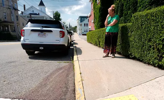 Frances Mercanti-Anthony, from Bristol, Maine, stands near the scene where blood is seen on the pavement after a shooting involving U.S. Immigration and Customs Enforcement, Monday, July 13, 2026 in Biddeford, Maine. (AP Photo/Robert F. Bukaty)