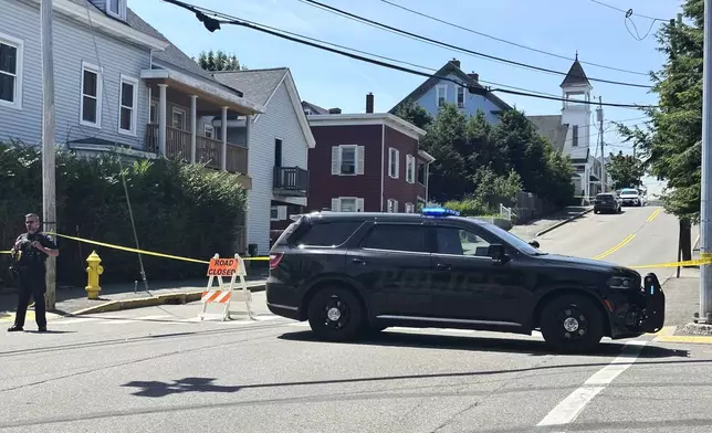 Police block a road after a shooting in Biddeford, Maine, Monday, July 13, 2026. (AP Photo/Patrick Whittle)