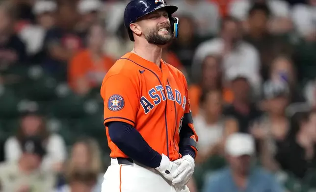 Houston Astros' Christian Walker reacts after getting hit by a pitch on his hand by Baltimore Orioles relief pitcher Anthony Nunez during the sixth inning of a baseball game, Friday, July 17, 2026, in Houston. (AP Photo/Karen Warren)