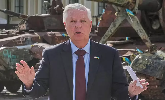 U.S. Sen. Lindsey Graham, R-S.C. answers a question from a media member near damaged Russian vehicles on display in central Kyiv, Ukraine, Friday, July 10, 2026. (AP Photo/Efrem Lukatsky)