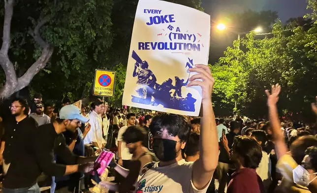 A protestor holds a placard with the message "Every Joke is a Tiny Revolution" during a demonstration demanding educational reforms as part of the Cockroach Janta Party's ongoing protest movement in New Delhi, India, Thursday, July 23, 2026. (AP Photo/Verda Sabzwari)