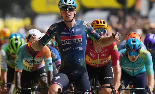 Belgium's Tim Merlier celebrates as he crosses the finish line to win the seventh stage of the Tour de France cycling race with start in Hagetmau and finish in Bordeaux, France, Friday, July 10, 2026. (AP Photo/Thibault Camus)