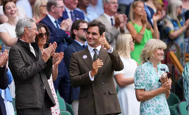 Former tennis player Roger Federer of Switzerland stands in the Royal Box on day eight at the Wimbledon Tennis Championships in London, Monday, July 6, 2026.(AP Photo/Kirsty Wigglesworth)