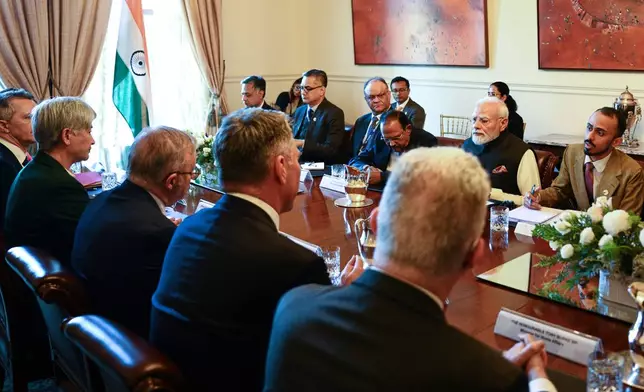 India's Prime Minister Narendra Modi, second right, talks to Australian Prime Minster Anthony Albanese, third left, during the Annual Leaders' Summit at Government House in Melbourne, Australia, Thursday, July 9, 2026. (Izhar Khan Pool via AP)