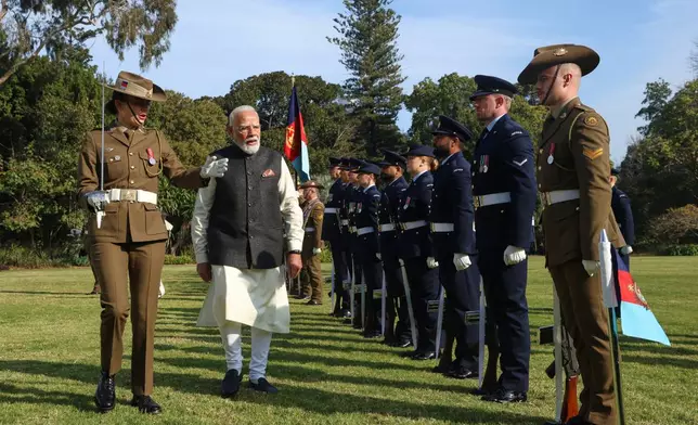 Indian Prime Minister Narendra Modi inspects a guard of honour during a ceremonial welcome at Government House in Melbourne, Australia, Thursday, July 9, 2026. (AP Photo/Hamish Blair)