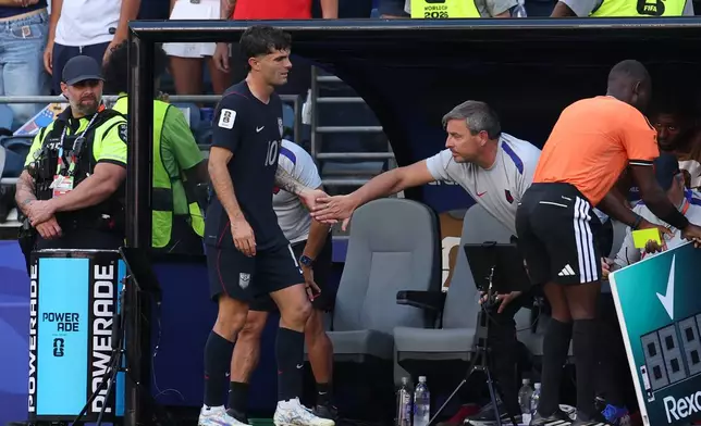 United States' Christian Pulisic (10) is greeted by a team member as he is being substituted during the World Cup round of 16 soccer match between the United States and Belgium in Seattle, Monday, July 6, 2026. (AP Photo/Maddy Grassy)