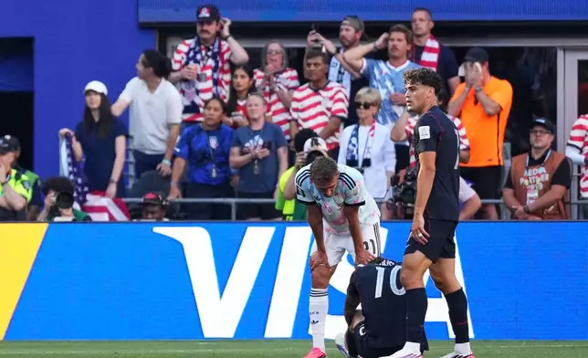 United States' Christian Pulisic (10) is looked after by Giovanni Reyna (7) and Belgium's Timothy Castagne (21) after being injured during the World Cup round of 16 soccer match in Seattle, Monday, July 6, 2026. (AP Photo/Ted S. Warren)