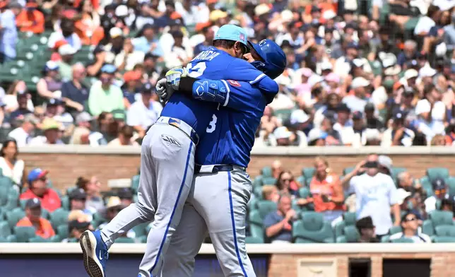 Kansas City Royals designated hitter Salvador Perez, right, hugs coach Miguel Garcia after Perez hit a home run during the seventh inning of a baseball game against the Detroit Tigers, Saturday, July 25, 2026, in Detroit. (AP Photo/Jose Juarez)