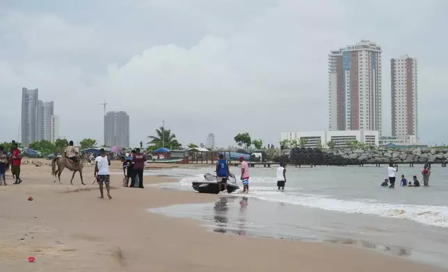 Beachgoers play at Takwa Bay beach in Lagos, Nigeria, Sunday, June 28, 2026. (AP Photo/Sunday Alamba)