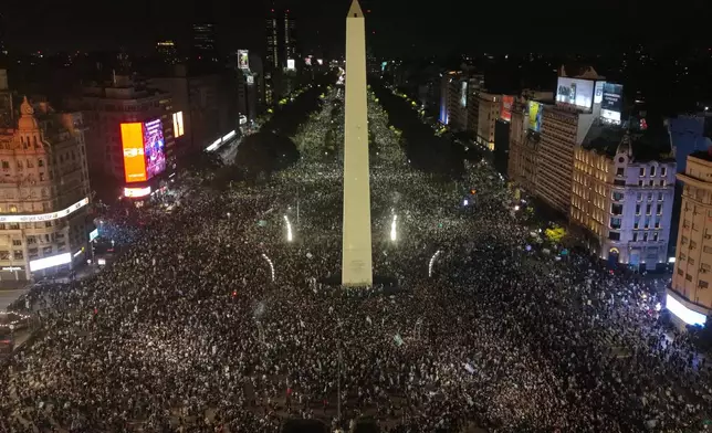 Fans celebrate Argentina's victory over England in a World Cup semifinal soccer match around the Obelisk in downtown Buenos Aires, Argentina, Wednesday, July 15, 2026. (AP Photo/Rodrigo Abd)