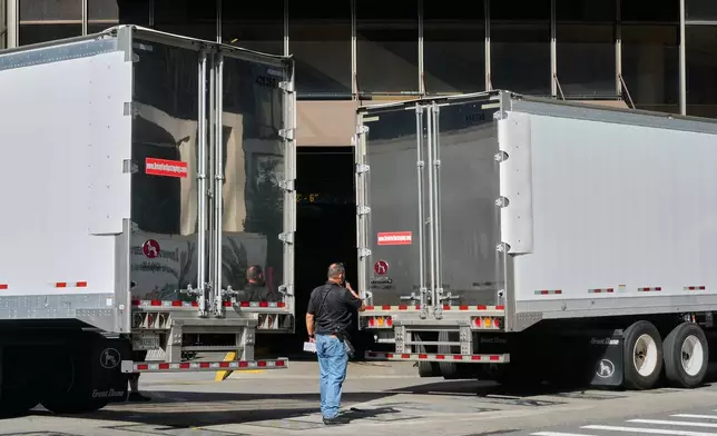 Trucks are moved into position to block photographer's view of the loading dock at New York's Madison Square Garden, Wednesday, July 1, 2026. (AP Photo/Richard Drew)