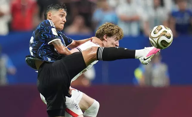 Argentina's Nahuel Molina (26) challenges for the ball with England's Anthony Gordon (18) during the World Cup semifinal soccer match between England and Argentina in Atlanta, Wednesday, July 15, 2026. (AP Photo/Jeff Roberson)