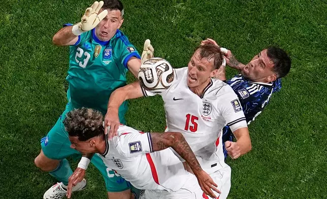 England's Nico O'Reilly (3) and Dan Burn (15) battle for the ball against Argentina's Emiliano Martínez (23) and Nicolás Otamendi (19) during the World Cup semifinal soccer match between England and Argentina in Atlanta, Wednesday, July 15, 2026. (AP Photo/George Walker IV)