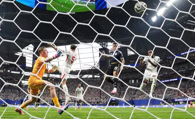 Argentina's Lautaro Martinez (22) scores their second goal past England goalkeeper Jordan Pickford (1) during the World Cup semifinal soccer match between England and Argentina in Atlanta, Wednesday, July 15, 2026. (AP Photo/Jacob Kupferman)