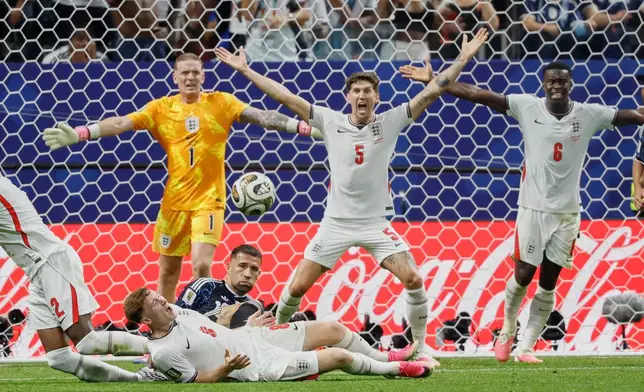England goalkeeper Jordan Pickford (1), John Stones (5) and Marc Guehi (6) react during the World Cup semifinal soccer match between England and Argentina in Atlanta, Wednesday, July 15, 2026. (AP Photo/Erik S. Lesser)