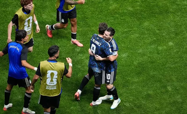 Argentina's Julian Alvarez (9) and Lionel Messi (10) celebrate after a goal scored by teammate Enzo Fernandez during the World Cup semifinal soccer match between England and Argentina in Atlanta, Wednesday, July 15, 2026. (AP Photo/Mike Stewart)