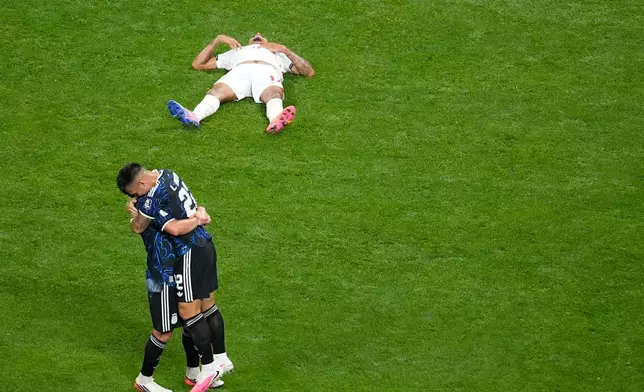 Argentina's Lautaro Martinez (22), right, hugs a teammate at the end of the World Cup semifinal soccer match between England and Argentina in Atlanta, Wednesday, July 15, 2026. (AP Photo/Mike Stewart)