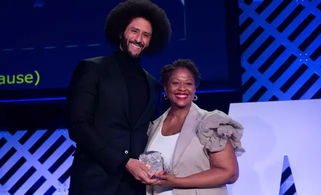 Colin Kaepernick, left, is presented with the ACLU Ralph Ellison Award for Defenders of Civil Rights and Civil Liberties in the Arts, Business, Science, and Sports by Deborah Archer at the ACLU's 2026 Biennial Leadership Conference,Friday, July 24, 2026, in Washington. (AP Photo/Kevin Wolf)