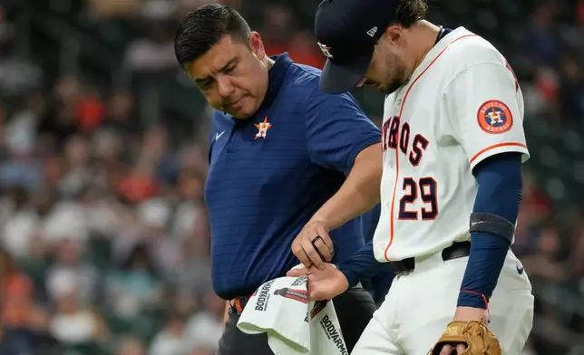 Houston Astros shortstop Raynel Delgado (29) leaves the game after trying to field a single by Minnesota Twins' Trevor Larnach during the fifth inning of a baseball game Wednesday, July 1, 2026, in Houston. (AP Photo/David J. Phillip)
