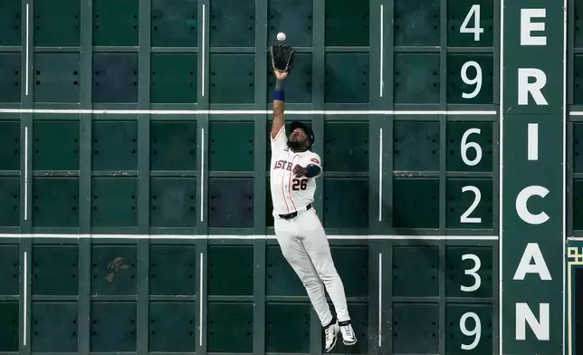 Houston Astros left fielder Taylor Trammell catches a fly ball by Minnesota Twins' Josh Bell during the ninth inning of a baseball game Wednesday, July 1, 2026, in Houston. (AP Photo/David J. Phillip)