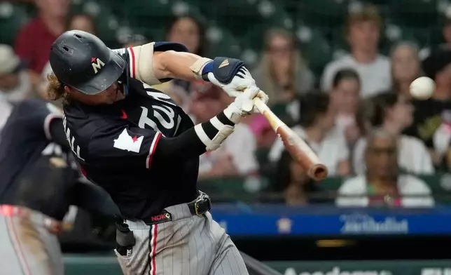 Minnesota Twins' Luke Keaschall hits a home run against the Houston Astros during the eighth inning of a baseball game Wednesday, July 1, 2026, in Houston. (AP Photo/David J. Phillip)