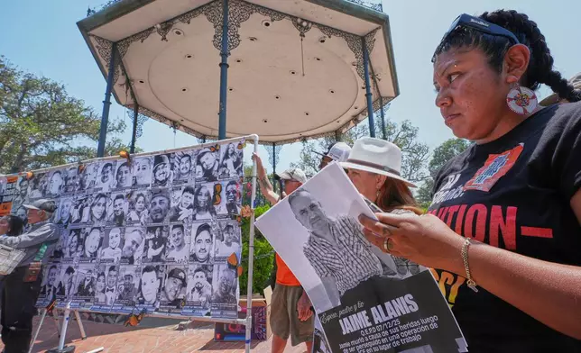 FILE - Activist and farm worker Xochitl Nunez, right, holds up a picture of late farm worker Jaime Alanis as she joins farmworkers, immigrant leaders, labor allies and organizers to announce a national, "Farmworker Strike for Dignity," during a news conference at La Placita Olvera in Los Angeles, July 14, 2025. (AP Photo/Damian Dovarganes, File)