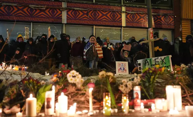 FILE - People gather during a vigil for 37-year-old Alex Pretti, who was fatally shot by a U.S. Border Patrol officer earlier in the day, Jan. 24, 2026, in Minneapolis. (AP Photo/Adam Gray, File)