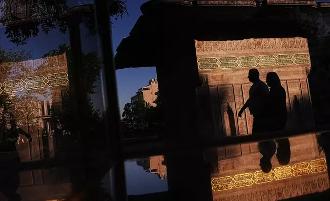 People walk past the Ottoman-era style Tophane public fountain in Istanbul, Turkey, Sunday, July 12, 2026. (AP Photo/Francisco Seco)