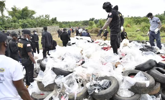 Liberian law enforcement agency officials prepare to burn cocaine consignments in Caraysburg in the outskirts of Monrovia, Liberia, Thursday, July 30, 2026. (AP Photo/Alexander Wiaplah)