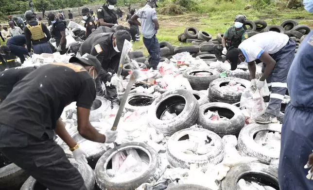 Liberian law enforcement agency officials prepare to burn cocaine consignments in Caraysburg in the outskirts of Monrovia, Liberia, Thursday, July 30, 2026. (AP Photo/Alexander Wiaplah)