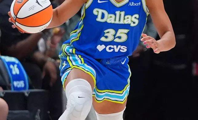 Dallas Wings guard Azzi Fudd dribbles during the first half of a WNBA basketball game against the Chicago Sky in Dallas, Sunday, July 12, 2026. (AP Photo/LM Otero)