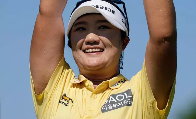 Haeran Ryu, of South Korea, celebrates after winning the Evian Championship women's golf tournament, in Evian, eastern France, Sunday, July 12, 2026. (AP Photo/Laurent Cipriani)