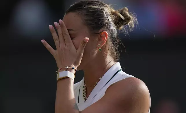 Aryna Sabalenka of Belarus reacts to losing against Naomi Osaka of Japan in their fourth round women's singles match at the Wimbledon Tennis Championships in London, Sunday, July 5, 2026. (AP Photo/Brian Inganga)