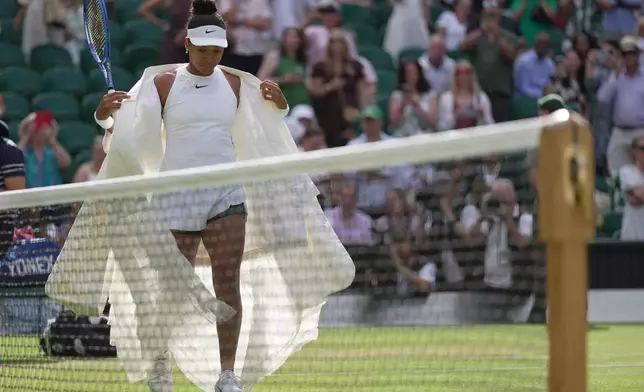 Naomi Osaka of Japan enters the centre court to play against Aryna Sabalenka of Belarus in their fourth round women's singles match at the Wimbledon Tennis Championships in London, Sunday, July 5, 2026. (AP Photo/Brian Inganga)