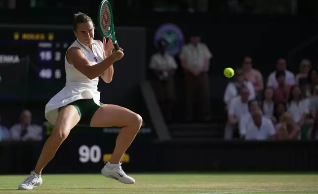 Aryna Sabalenka of Belarus returns the ball to Naomi Osaka of Japan in their fourth round women's singles match at the Wimbledon Tennis Championships in London, Sunday, July 5, 2026. (AP Photo/Brian Inganga)