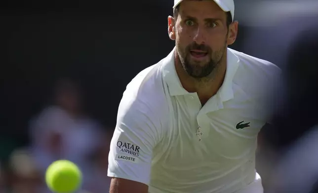 Novak Djokovic of Serbia eyes the ball as he prepares tu return it to Roman Saffiulin of Russia in their fourth round men's singles match at the Wimbledon Tennis Championships in London, Sunday, July 5, 2026. (AP Photo/Brian Inganga)