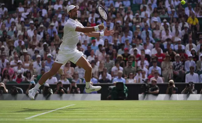 Novak Djokovic of Serbia returns the ball to Roman Saffiulin of Russia in their fourth round men's singles match at the Wimbledon Tennis Championships in London, Sunday, July 5, 2026. (AP Photo/Brian Inganga)